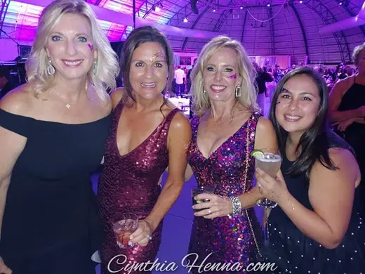 Four guests at an evening gala wearing glitter glam eye designs