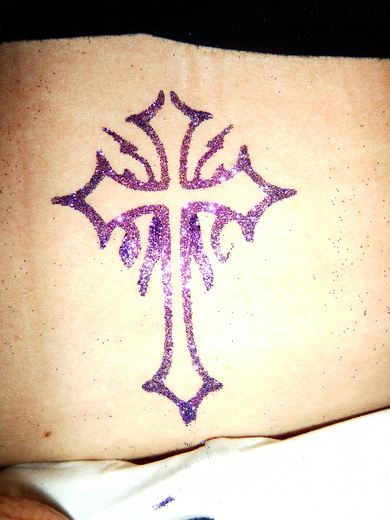 Purple glitter cross on a shoulder