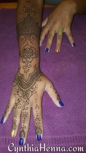 Detailed henna sleeve across the hand and wrist with glitter dusted on top